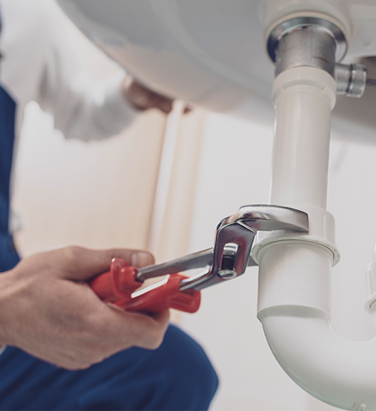 Plumber fixing a sink at home