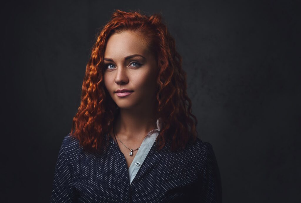 Redhead female supervisor dressed in an elegant suit.